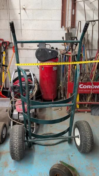 Green handcart for moving barrels, primary view