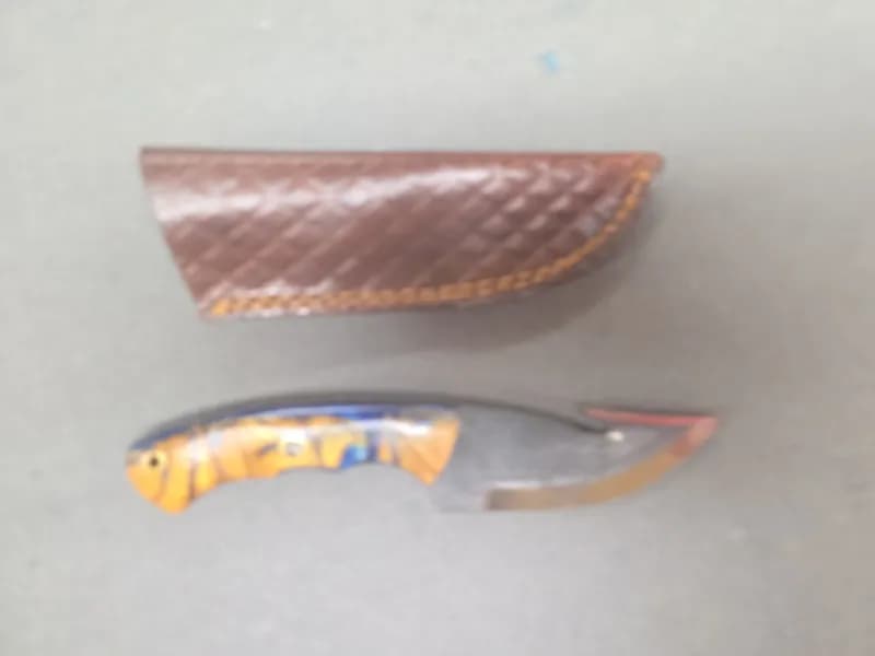 Fixed Blade Gut Hook Knife with Blue and Amber Resin Handle and Leather Sheath, side view